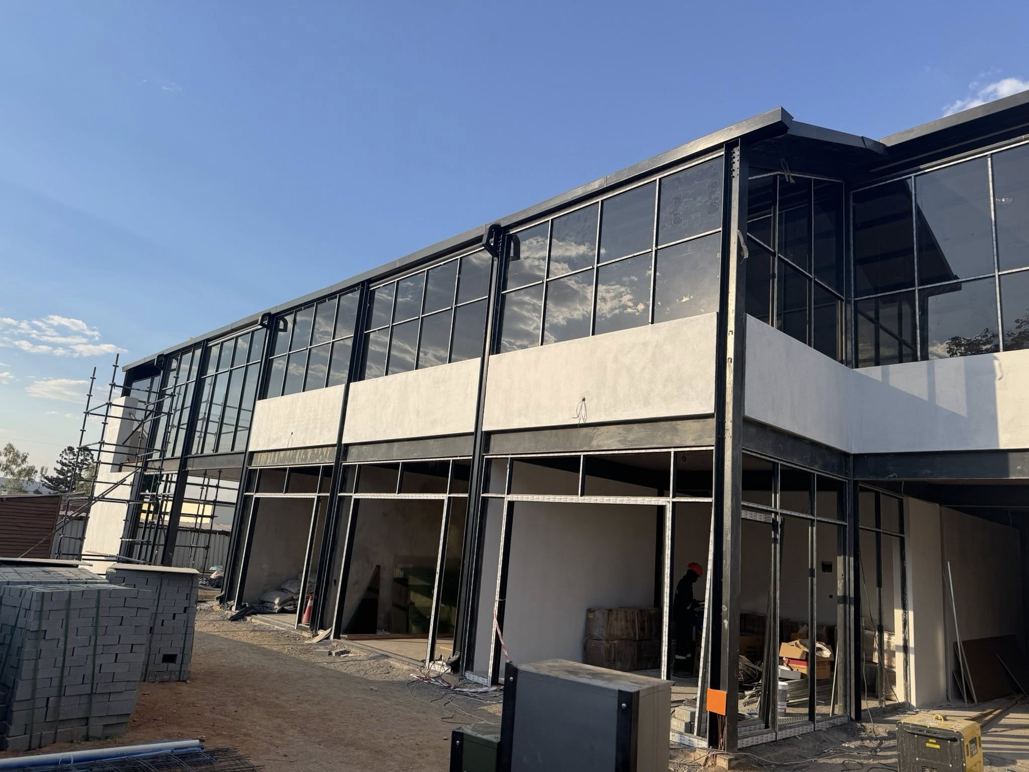 Modern aluminium and fenestration projects featuring sleek glass doors, windows, and façades for residential and commercial buildings.